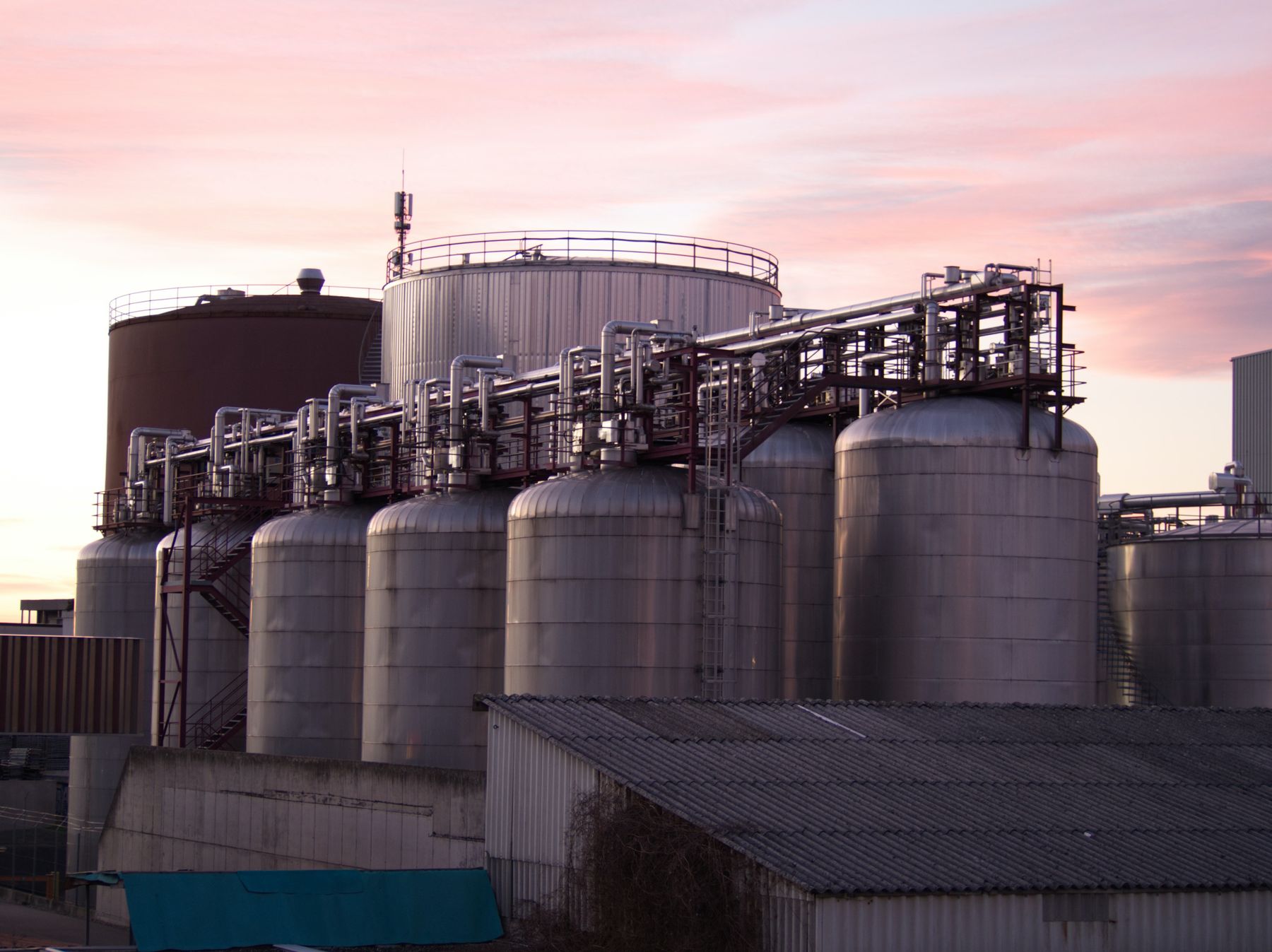 Representative industrial processing facility with storage tanks and piping